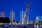 Netherlands, Southern Holland, Rotterdam, Southbank area along the Nieuwe Maas with the outdoor maritime museum and a crane in the foreground