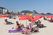 Brazil, state of Rio de Janeiro, city of Rio de Janeiro, Copacabana beach, Carioca landscapes between the mountain and the sea classified UNESCO World Heritage, girls chatting and line of apartment buildings in the background