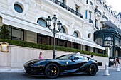 Principalty of Monaco, Monaco, Monte Carlo, Hotel de Paris, luxury hotel, property of the Societe des Bains de Mer overlooking on Place du Casino with Le Louis XV gastronomic restaurant owned by Alain Ducasse, luxury car