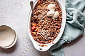 Apple rhubarb crisp in an oval baking dish