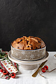A traditional panettone on a carefully laid table for the Christmas festivities. Some of the ingredients are sultanas, butter, egg, sugar, flour and candied fruit