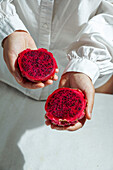 Dragon fruit,also known as pitaya,sliced pink-magenta coloured flesh with tiny black seeds,tropical fruit