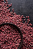Adzuki beans in a bowl on a black background