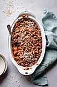 Apple rhubarb crisp in an oval baking dish