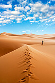 Woman alone in the Sahara Desert, Erg Murzuq, Sahara Desert, Fezzan, Libya, North Africa. (MR)