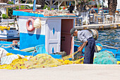 Fisherman working, Livadi, Serifos Island, Cyclades, Greek Islands, Greece, Europe