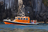 View of the rescue fishery patrol boat Wave Dancer at the wreck of the MS Oliva on Nightingale island, Tristan da Cunha Group, South Atlantic Ocean