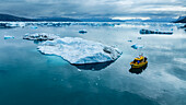 Aerial of a little boat anchoring in the Nuuk Icefjord, Western Greenland, Denmark, Polar Regions