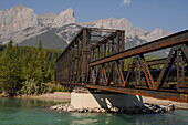 Bow River Iron Bridge and Mount Lawrence Grassi on a hazy summer evening caused by wildlife smoke, Canmore, Alberta, Canadian Rockies, Canada, North America