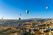 Aerial view of hot air balloons over rock formations at sunrise, Goreme, Goreme Historical National Park, UNESCO World Heritage Site, Cappadocia, Central Anatolia Region, Anatolia, Turkey, Asia Minor, Asia