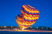 Two colorful hot air balloons at launch at twilight, Goreme, Cappadocia, Anatolia, Turkey, Asia Minor, Asia