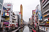 View along the channels, walking paths and bridges along Dotonbori River on an overcast day, Osaka, Honshu, Japan, Asia