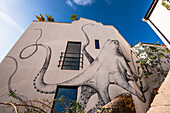 Kraken Street art on white walls, Gibraltar Castle Steps, beautiful residential area on the hill of narrow alleys, Gibraltar, Europe