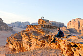 Man sitting in the Wadi Rum desert at dusk, Jordan, Middle East