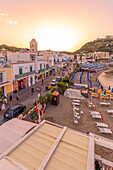 Elevated view of beach and the town of Lacco Ameno at sunset, Island of Ischia, Campania, Italy, Europe