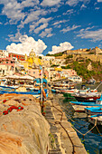 View of fishing nets and boats in Marina di Corricella and Church of Santa Maria delle Grazie in background, Procida, Phlegraean Islands, Gulf of Naples, Campania, Southern Italy, Italy, Europe