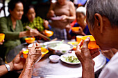 A group of friends enjoy a meal at a vegetarian restaurant, An Giang Province, Mekong Delta, Vietnam, Indochina, Southeast Asia, Asia, Asia