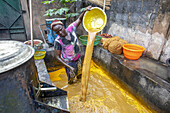 Villager making palm oil in Dokoue, Benin, West Africa, Africa