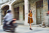 Young Indonesian girl posing in a batik dress in the Kepodang Street, Old Town of Semarang, Java island, Indonesia, Southeast Asia, Asia