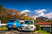 Parked cars in front of the summit, Mount Fujiyama (Mount Fuji), UNESCO World Heritage Site, iconic volcano in autumn, Honshu, Japan, Asia