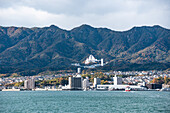 City at the foot of a mountain at the inland sea, Miyajima, Hiroshima Prefecture, Honshu, Japan, Asia