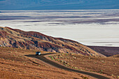 Car driving along the road in Death Valley, California, United States of America, North America