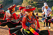 Peruvian women in traditional dresses dancing on celebration, Chinchero, Peru, South America