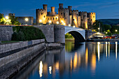 Conwy Castle (Castell Conwy), UNESCO World Heritage Site, across the River Conwy at night, Conwy, Conwy County Borough, North Wales, United Kingdom, Europe