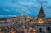 Ancient city view with traditional stone houses, Maria Santissima della Bruna and Sant'Eustachio Cathedral and Church of Saint Peter Barisano at sunset, Matera, Basilicata, Italy, Europe