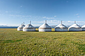 Traditional yurts dotting the picturesque landscapes near Song-Kol Lake in bright daylight, Kyrgyzstan, Central Asia, Asia