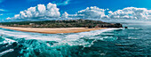 Aerial drone panoramic view of North Beach, with the iconic Sao Miguel Arcanjo lighthouse on the right, as well as the city of Nazare, Oeste, Estremadura, Portugal, Europe