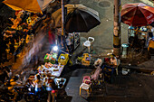 Street vendors near a metro station in Medellin, Colombia. The metro includes street level trains and even aerial cable cars to connectthe city's downtown to the poorer neighborhoods in the surrounding mountains.