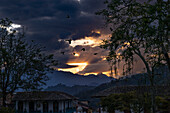 The sun sets in the hills surrounding the charming colonial town of Jardin, Colombia.