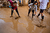 People cleaning. Effects of the DANA floods of October 29, 2024, Pelayo street, Paiporta, Comunidad de Valencia, Spain