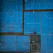 Aerial view of blue basketball and sports courts in school playground