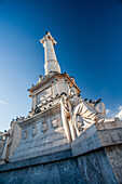 The impressive monument of King Dom Pedro IV stands tall in Rossio Square, surrounded by charming architecture and a vibrant atmosphere.