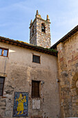 The bell tower of the Church of Santa Maria Assunta in the walled medieval town of Monteriggioni, Italy.