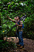 George of the Cloud Forest, guide and specialist, guides a young woman through Monterey cloud forest during fauna tour, Costa Rica