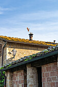 A metal weathervane rooster in the medieval walled town of Monteriggioni, Sienna, Tuscany, Italy.