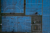 Aerial view of blue basketball and sports courts in school playground