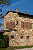 Traditional architecture of a farmhouse on a lavender farm in Sienna Province, Italy.