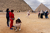 Tourists at the Great Pyramids complex, Giza, Egypt.