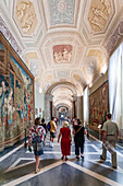 Rome, Italy, July 22 2017, Tourists admire intricate tapestries while visiting the Vatican Museums' stunning tapestry room in Rome.