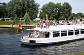 Berlin, Germany, July 29 2009, A boat glides along the Spree River in Berlin, offering passengers scenic views of the city’s landmarks and greenery.