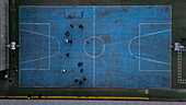 Aerial view of blue basketball and sports courts in school playground