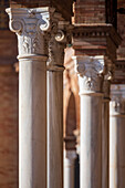 Close up view of ornate columns showcasing intricate details at the stunning Plaza de España in Seville, Spain, highlighting the elegance and craftsmanship of Spanish architecture.