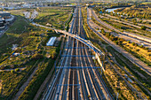 Aerial view of a bridge over the train tracks at sunset