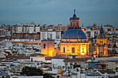 A breathtaking aerial view showcasing the barroque church of San Luis de los Franceses and the mudejar church of Santa Marina in Seville, Spain. The iconic architecture stands amidst the urban landscape.