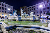 Rome, Italy, July 2017, The Neptune fountain is illuminated at night, surrounded by a lively atmosphere in Navona square, capturing the beauty of Rome.