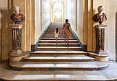 Rome, Italy, July 22 2017, A mother and her daughter climb the grand staircase of the Doria Pamphili Gallery, enjoying their visit in Rome, Italy.